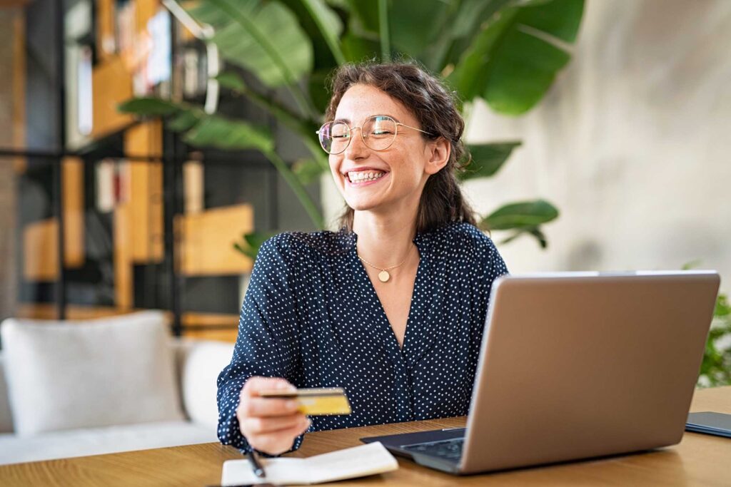 woman-with-laptop-using-credit-card-DZ35VKV-1.jpg